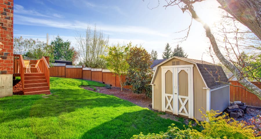 Fenced backyard with storage shed in Johnson City